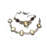 A silver colour bracelet set with five cameos, together with a matching necklace