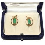 A pair of jade earrings set in gold colour metal