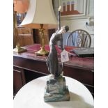 An Art Deco style figure of a lady dancing, after Demetre Chiparus, on a green marble