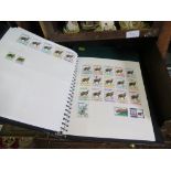 Two albums of world postage stamps, depicting wildlife, reptiles, fish and shells