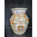 A Crown Ducal vase signed Charlotte Rhead, the ribbed vase with floral design in orange and green.