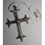 A silver cross in ornate design