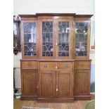 An early 19th century style mahogany breakfront bookcase, the cavetto moulded cornice over four
