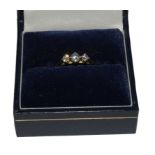 A three stone diamond ring set in 18 carat yellow gold