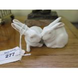 Royal Copenhagen pair of rabbits eating a lettuce leaf, model no. 518