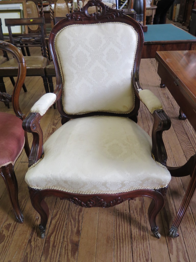 A French 19th century style open armchair, the acanthus carved top rail over an upholstered back,