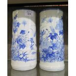 A pair of Japanese blue and white bamboo shape vases, with floral decoration 24cm high, unmarked (