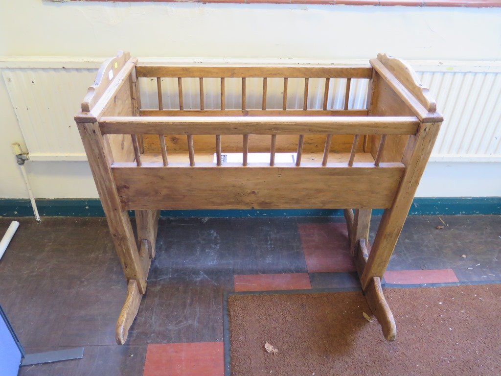 A pine cradle, with spindle sides, 91cm long, 87cm high, 72cm wide