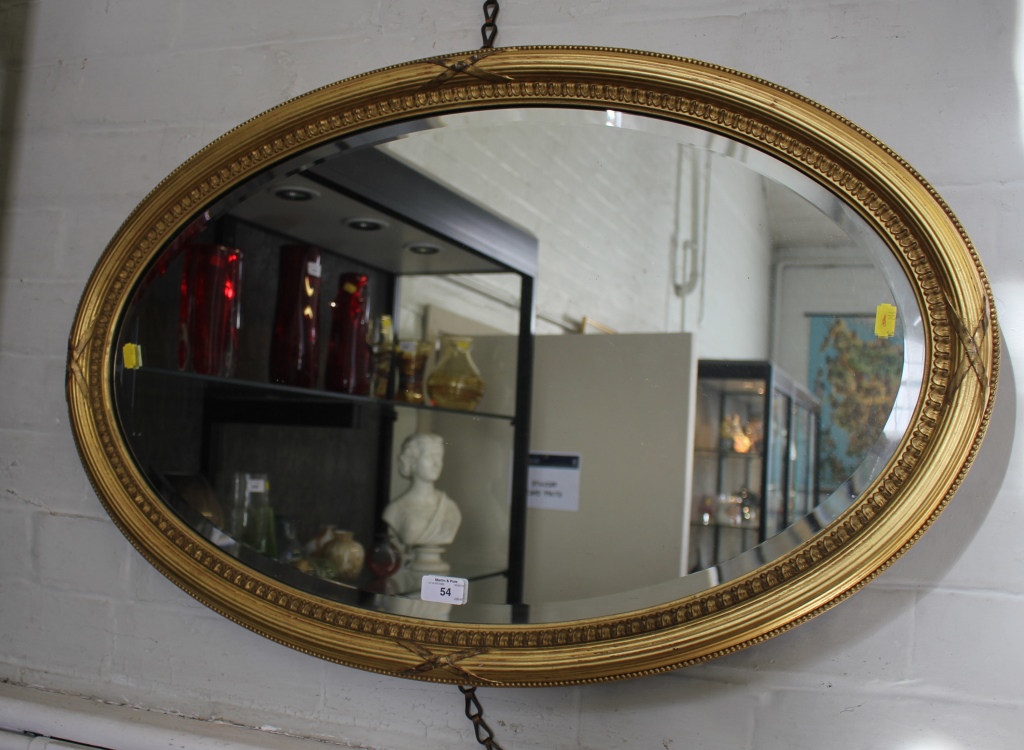 A Regency style giltwood framed oval wall mirror with bevelled plate 85cm x 54cm