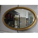 A Regency style giltwood framed oval wall mirror with bevelled plate 85cm x 54cm