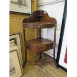 A 19th century mahogany corner washstand, the raised back over a frieze drawer on outsplayed legs