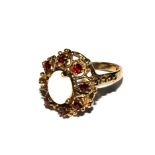 A garnet and opal ring set in 9 carat gold