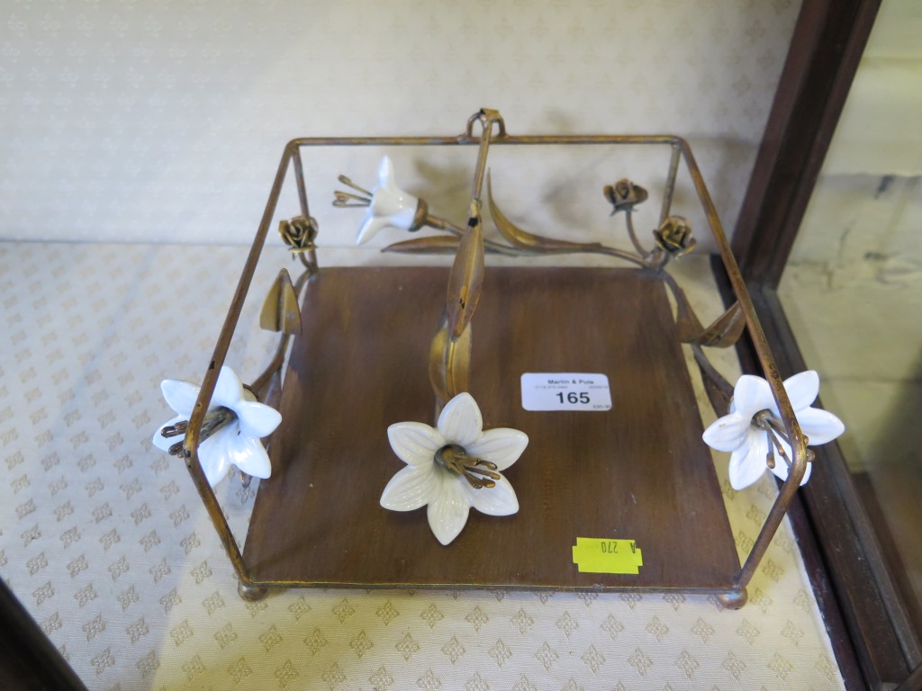An Art Nouveau table napkin holder, with ceramic flower head design