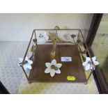 An Art Nouveau table napkin holder, with ceramic flower head design