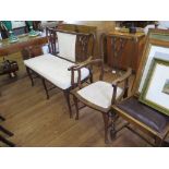 An Edwardian mahogany settee and armchair, with lancet arch design backs, padded seats and
