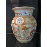 A Crown Ducal vase signed Charlotte Rhead, the ribbed vase with floral design in orange and green,