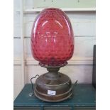 A pair of copper oil lanterns, with dimpled red glass shades, 45.5cm high