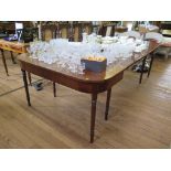 A George III style mahogany dining table, with rounded rectangular ends, two leaves and ring