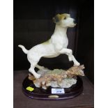 A cast model of a terrier dog on a mahogany stand with brass plaque inscribed Juliana collection