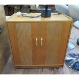 A teak hi-fi cabinet with twin doors, and compartments to hold records 63.5cm wide