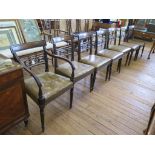 A set of seven late George III mahogany dining chairs, including one carver, the tablet top rails