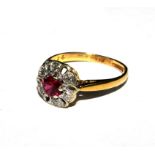 A diamond and synthetic ruby cluster ring set in 18 carat gold