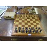 A vintage set of carved wood chessman with king size being 7cm high and a portable inlaid wood chess