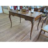 A Victorian French style ladies writing table, the leather inset top over a long frieze drawer on