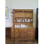 A pine dresser and rack, the rack with shelves and two drawers over a base with central breakfront