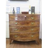 An early 19th century mahogany bowfront chest of drawers, with two short and three long graduated