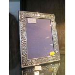 A Sheffield silver plated R. Carr decorative floral border photo frame 16.5cm x 12cm together with