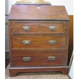 An Edwardian mahogany bureau, the sloping fall enclosing pigeonholes over three long graduated