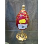 Sankyo ornamental musical egg trinket box with gilt painted and floral decoration on a gilt pedestal