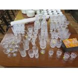 A pair of cut glass decanters, another decanter, and a large collection of glassware