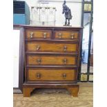 A George II style elm and mahogany crossbanded chest of drawers, with two short and three long