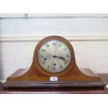 A 1930s inlaid walnut admiral hat mantel clock, the silvered dial with three train movement striking