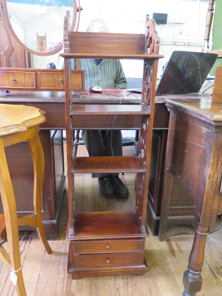 A 19th century style mahogany whatnot with four shelves, two drawers to the base and fret carved