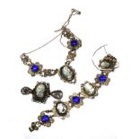 A silver colour bracelet, set with three cameos and deep blue stones, a matching necklace and a