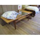 A G-Plan nest of three teak tables, labelled, and a glass top and teak coffee table