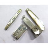 Two fruit knives, a cigar cutter, and a silver ingot