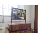 An early 19th century mahogany and boxwood bowfront toilet mirror, the rectangular plate over