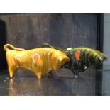 A Trentham art ware figure of a bull in yellow glaze, 30cm long, and another as a money box in green