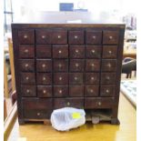 A 19th century mahogany apothecary cabinet, the sloping top over 30 small drawers and six larger