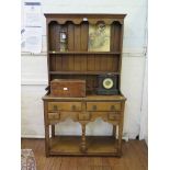 A small George III style oak dresser and rack, the rack with two shelves over a base with two