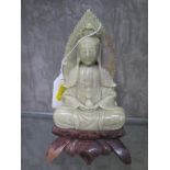 A soapstone Buddhist figure, on a lotus leaf base, 18.5cm high