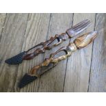 A vintage pair of African finely hand carved olive wood food servers with native facial profile