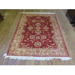 *A Zeigler style rug, the red field with allover palmette design and beige border 204cm x 136cm