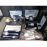 A collection of cased silver items to include egg cup and spoon, a childs fork, spoon and napkin