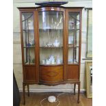An Edwardian inlaid mahogany bowfront display cabinet, the bowed centre flanked by cupboard doors
