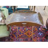 An early 19th century mahogany butler's tray, the oval top with hinged sides and later floral